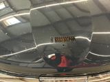 a reflection of a person in a mirror on the hood of a car
