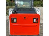 the back end of a small red utility vehicle parked in a parking lot