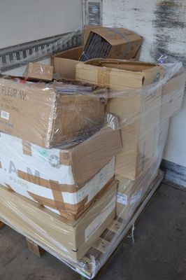 many boxes stacked on top of a pallet in a garage