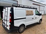 a white van that is parked in front of a building