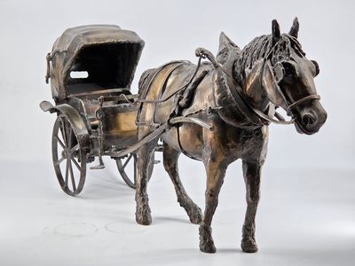 statue of a horse pulling a carriage with a covered seat