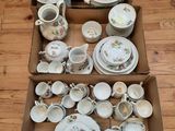 a box full of china on a wooden table