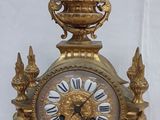 a gold clock that is sitting on a table