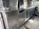 a kitchen with stainless steel cabinets and a chalk board on the wall