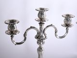 a silver candelab with three candles on it