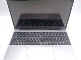 a silver laptop with a black keyboard sitting on a white surface