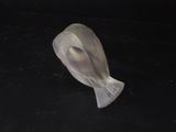 a plastic object on a black surface that looks like a bird