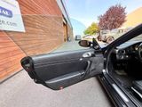 doorway view of a car with the door open and the driver ' s seat down