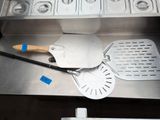 stainless steel counter top with utensils and spatulas on it