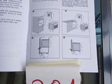 a book with instructions on it sitting on top of a stove