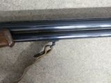 two shotguns that are sitting on the ground