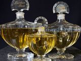 three bottles of perfume sitting next to each other on a table