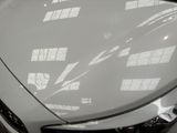 a close up of a car ' s hood with the sun shining through the windows