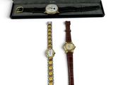 a couple of watches are sitting in a box on a white surface
