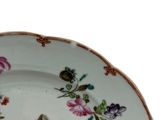 a white plate with a pink rose design on it