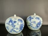two blue and white vases sitting on a table