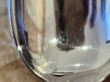 a silver spoon with a piece of cake on it