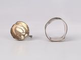 two silver rings with a gold shell on top and a silver ring with a gold shell on the bottom