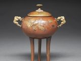 an image of a brown and gold vase with two lions on it