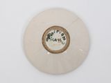a white plate with a brown and black design on it