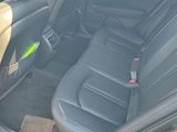 the back seats of a car with a remote control in it