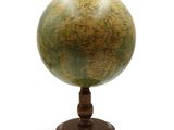 an old globe on a wooden stand on a white background