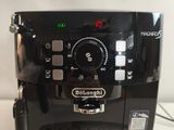 a black coffee maker that is sitting on a table