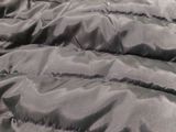 a cat that is laying on a bed with a blanket