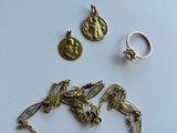 two gold birds and a coin are sitting on a white surface