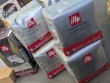 several packages of coffee sit on a table in a store