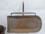 an old metal pan with a handle next to a bucket