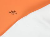 an orange and white shirt with a logo on the chest