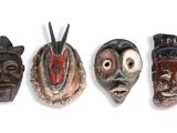 four masks are lined up in a row on a white surface