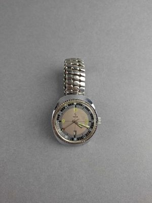 an image of a silver watch with a white face on a gray surface