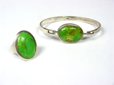 pair of silver and green stone rings on a white surface