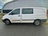 a white van that is parked in front of a building