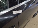 a black car with a sticker on the side of it