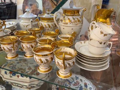 de nombreuses tasses et soucoupes posées sur une table en verre