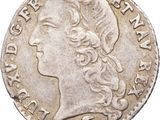 gros plan d'une pièce de monnaie sur laquelle figure une tête de femme