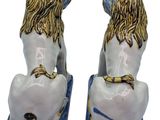 pair of blue and white ceramic lion bookends on blue base