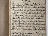 an old book with writing on it sitting on top of a table
