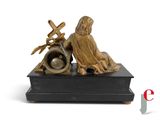 a statue of a man sitting on a box with a clock