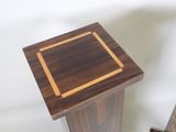 a small wooden table with a square design on it