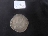 une pièce d'argent sur laquelle figure une femme