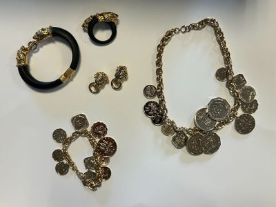 several pieces of jewelry are displayed on a white surface