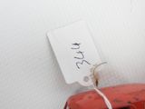 a small red object with a tag on it