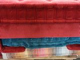 a red couch sitting on top of a wooden pallet