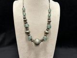 the necklace is made of glass beads and silver beads