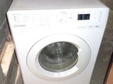 an image of a washing machine in the corner of a room