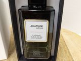 an image of a bottle of perfume sitting on a wooden table